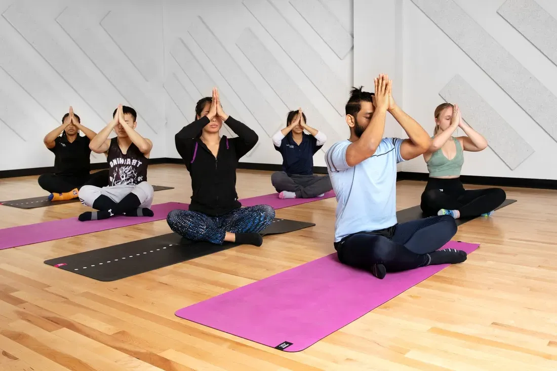 Group of people doing yoga at The Barnes Center at the Arch.